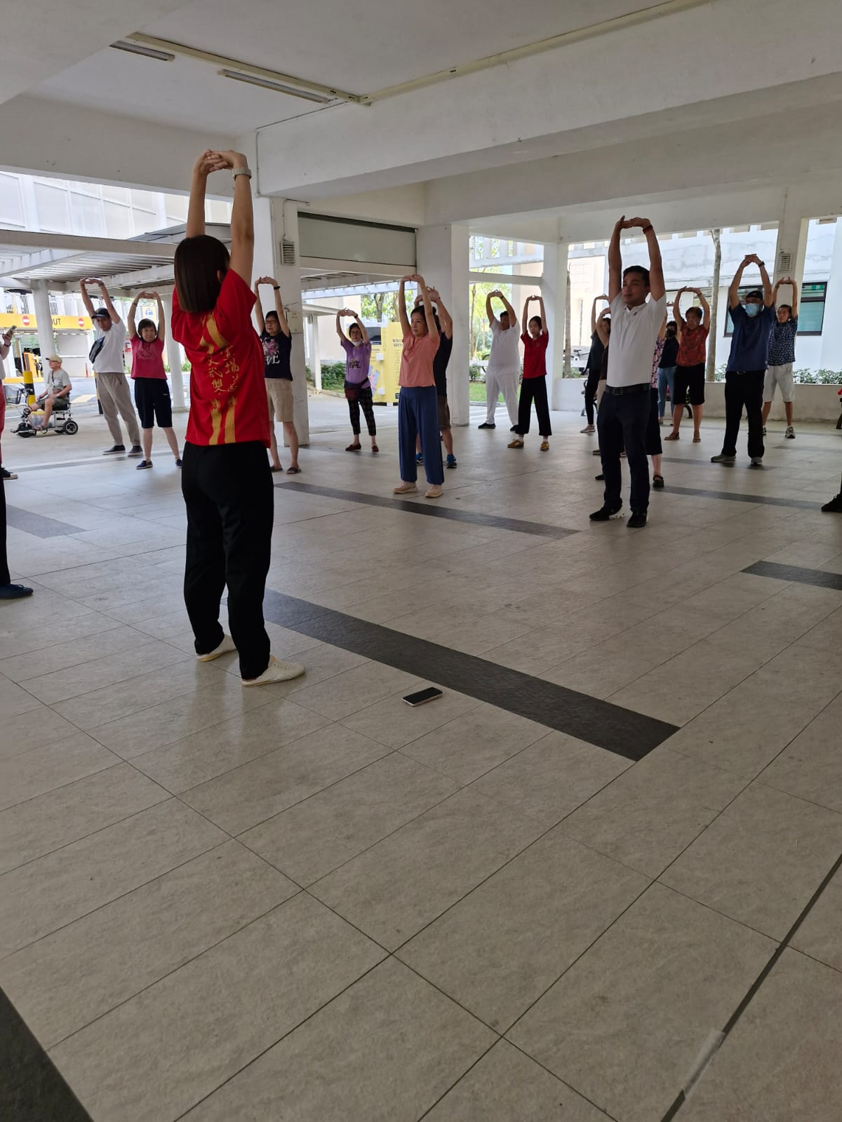 Coach Jennee showing the participants some stretching exercises